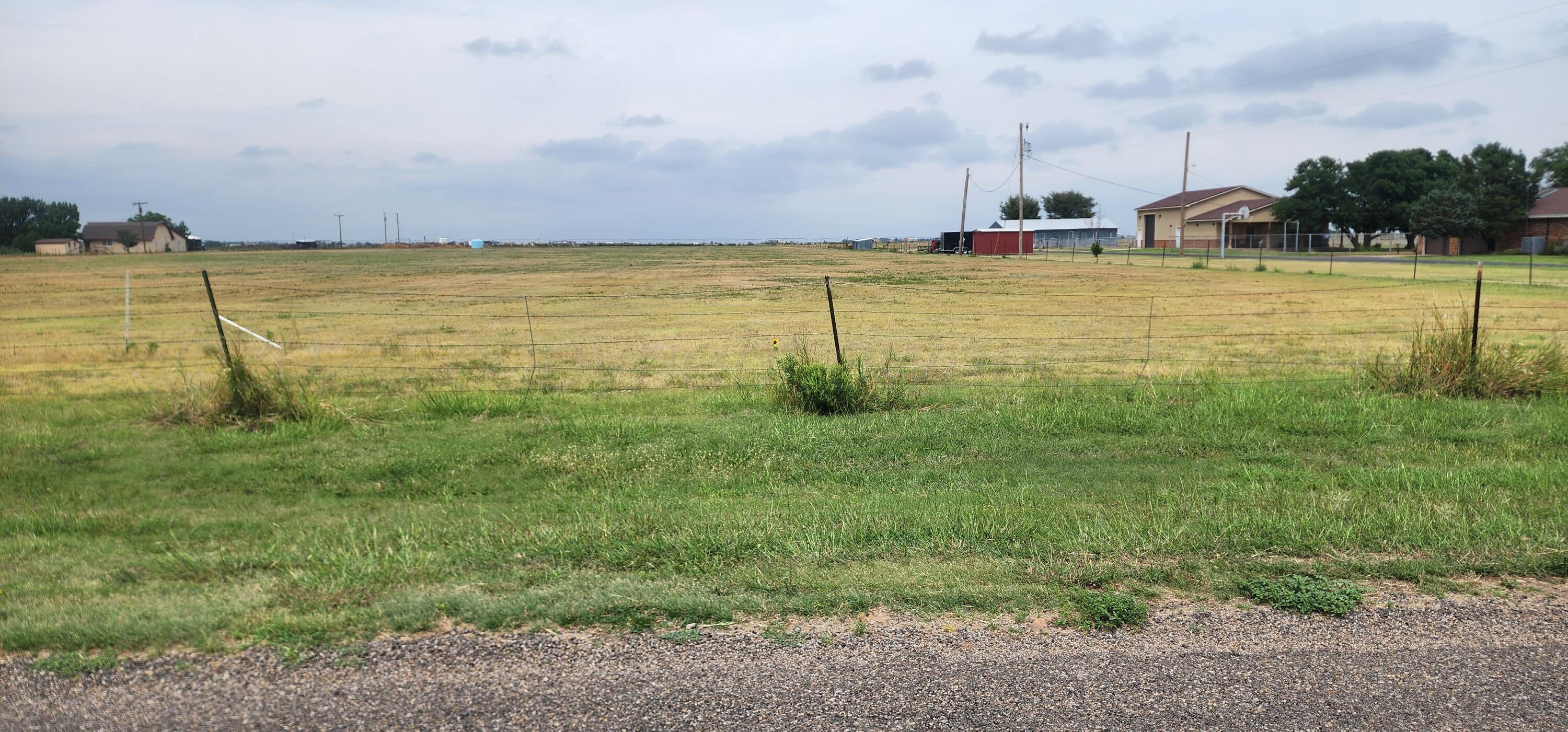 a view of a field with an ocean