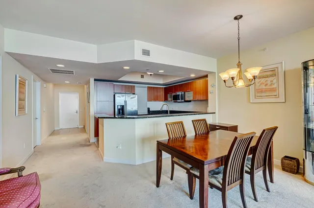 a kitchen with granite countertop a sink stove and microwave