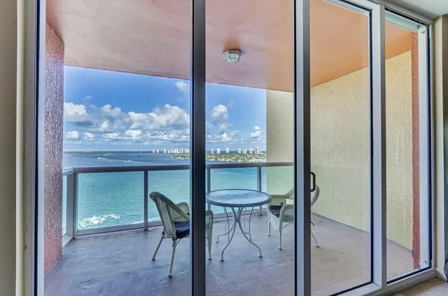 a front view of a house with swimming pool and outdoor seating