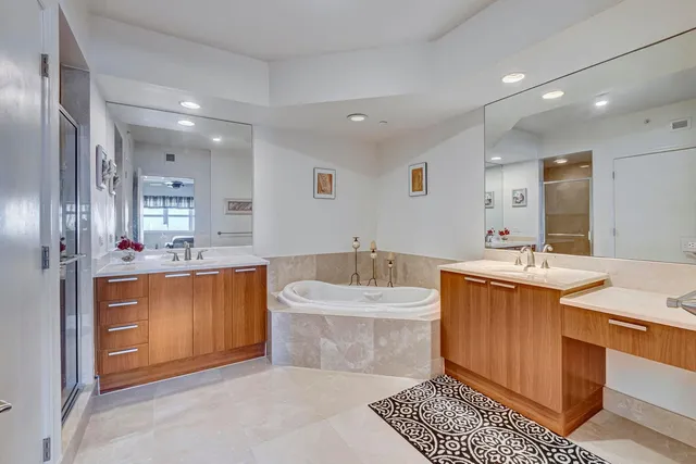 a view of swimming pool with seating space and trees in the background