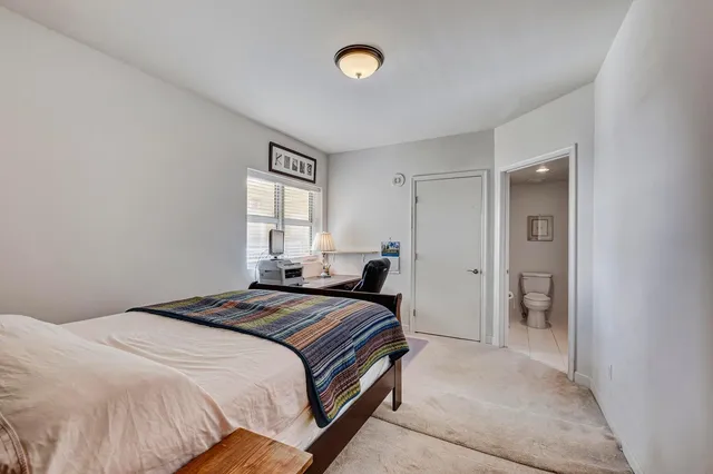a kitchen with granite countertop stainless steel appliances a refrigerator and a sink