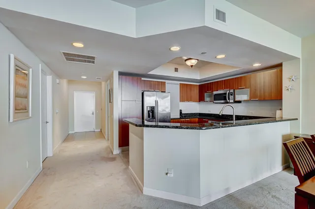 a kitchen with stainless steel appliances granite countertop a stove and a refrigerator
