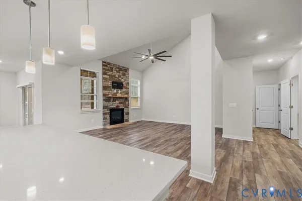 a bathroom with a granite countertop sink a toilet and a shower