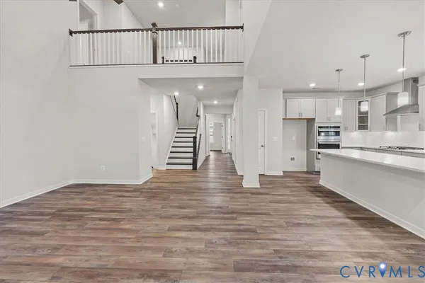 an empty room with a ceiling fan and window
