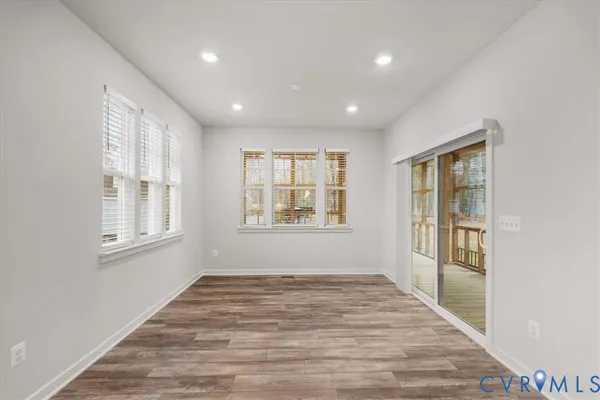 a view of an empty room with wooden floor