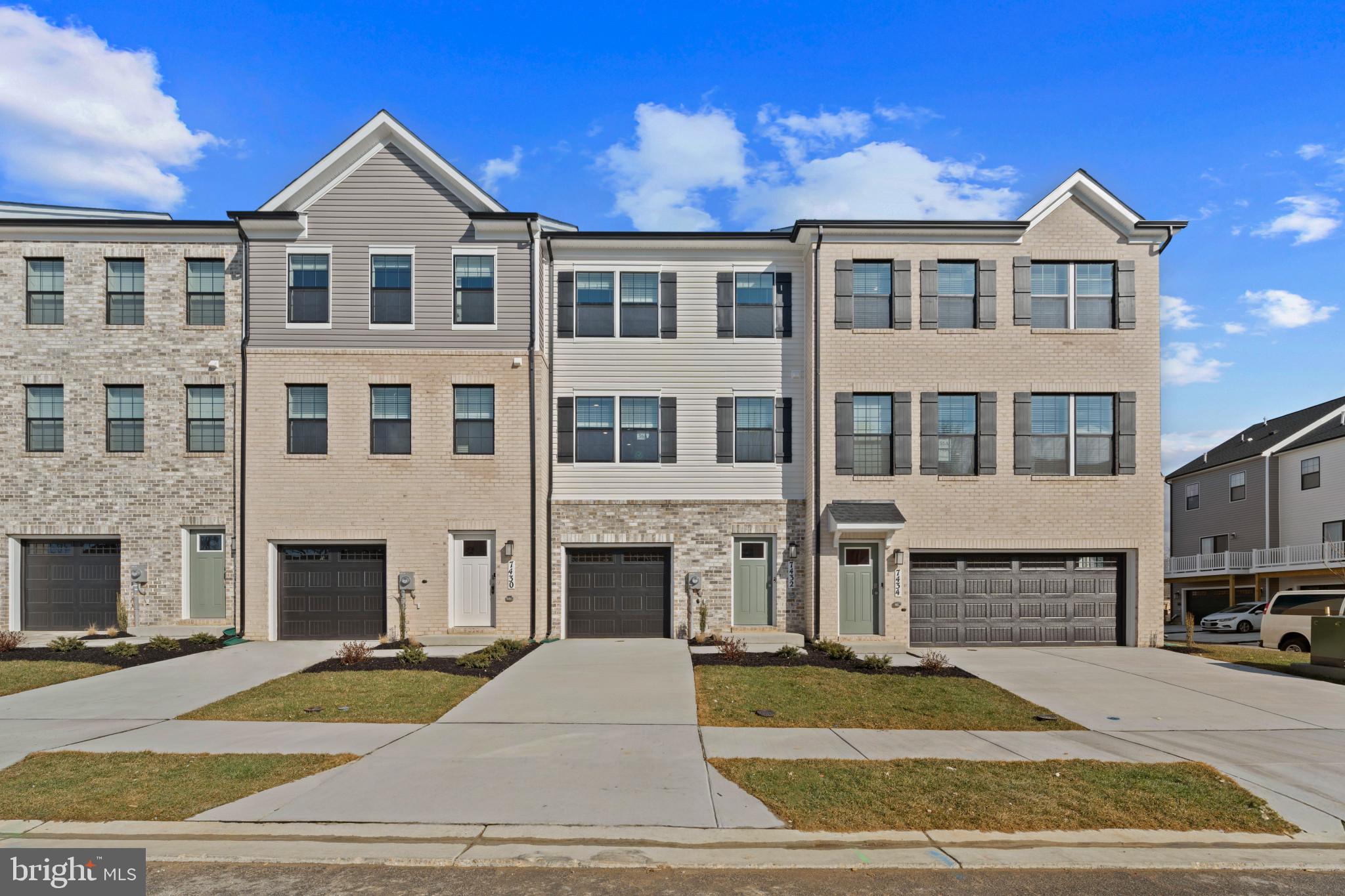 a front view of a building with a yard and a garage