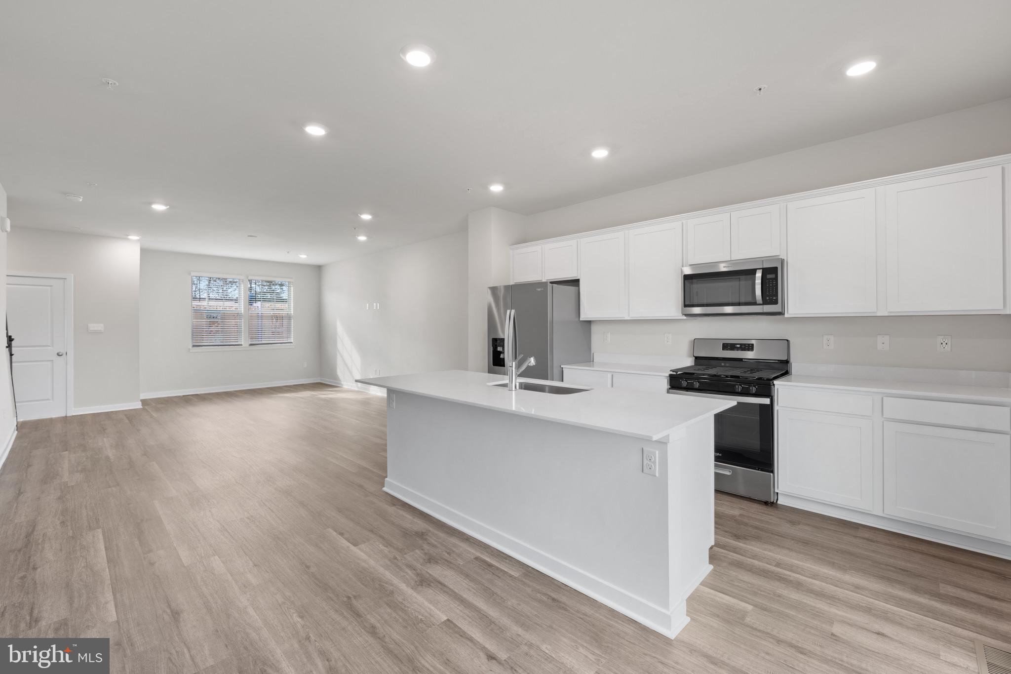 7512 Fern Gully Way Brandywine, MD 20613 - Photo 11 of 26 a kitchen with stainless steel appliances a refrigerator sink and microwave