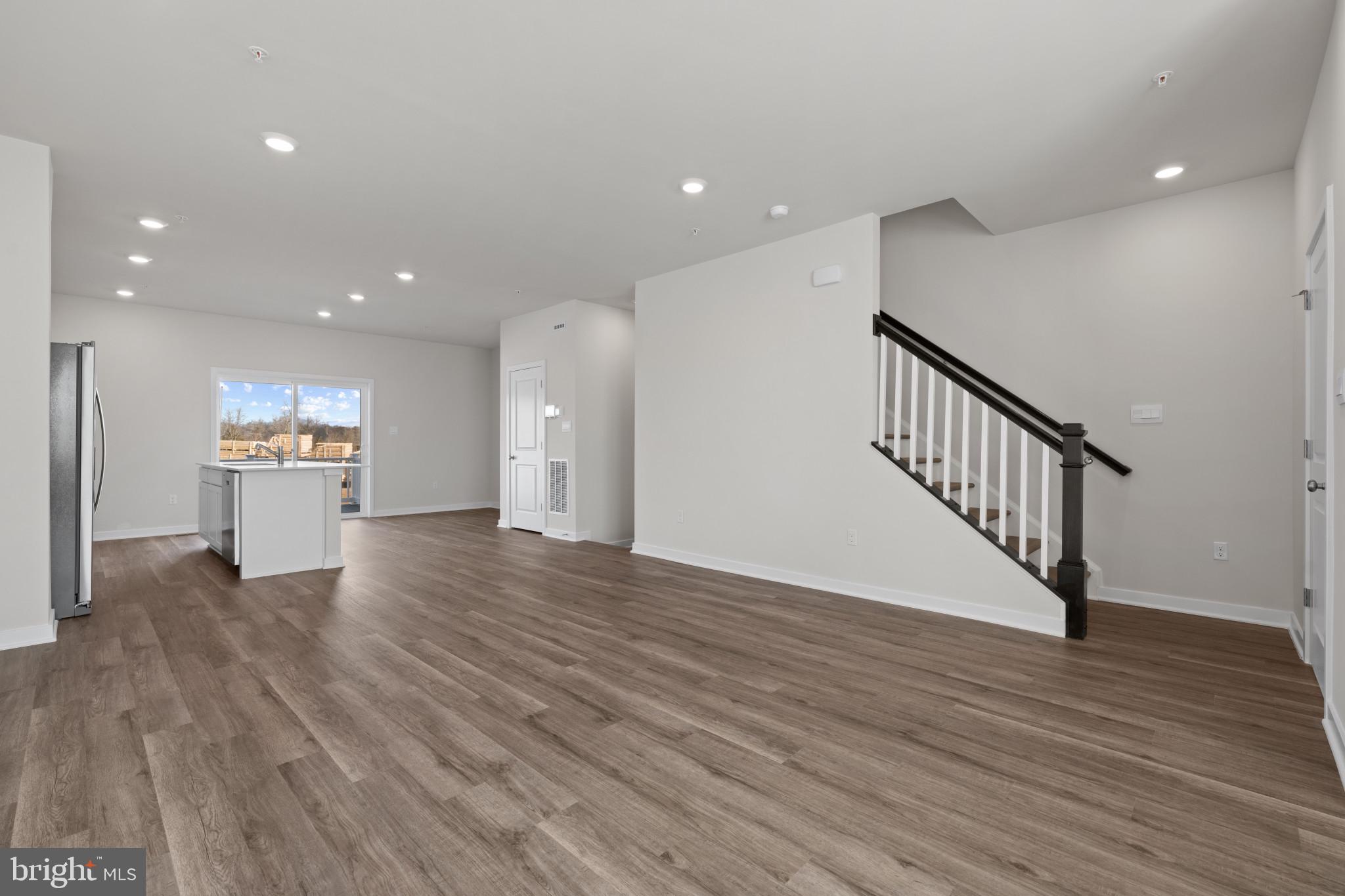 7512 Fern Gully Way Brandywine, MD 20613 - Photo 15 of 26 a view of an empty room with wooden floor kitchen view and a window