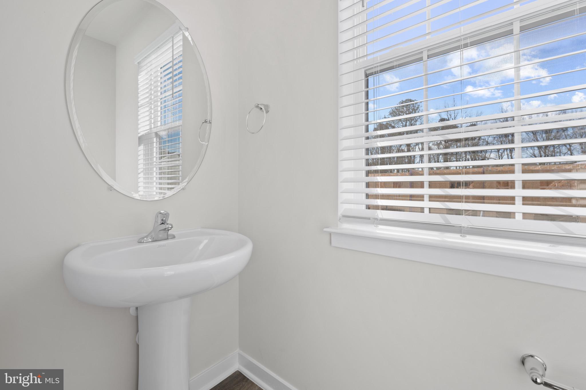 7512 Fern Gully Way Brandywine, MD 20613 - Photo 16 of 26 a bathroom with a sink a mirror and a window