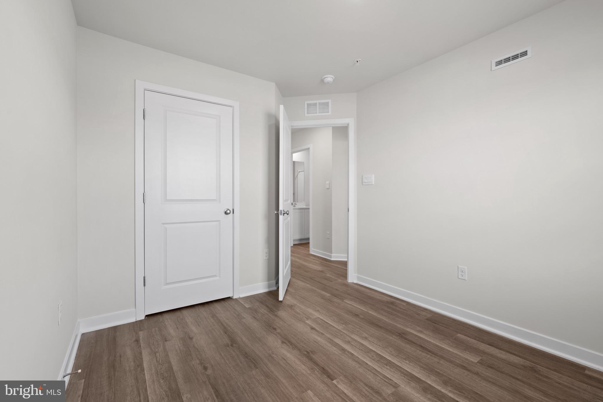 7512 Fern Gully Way Brandywine, MD 20613 - Photo 20 of 26 a view of an empty room with wooden floor