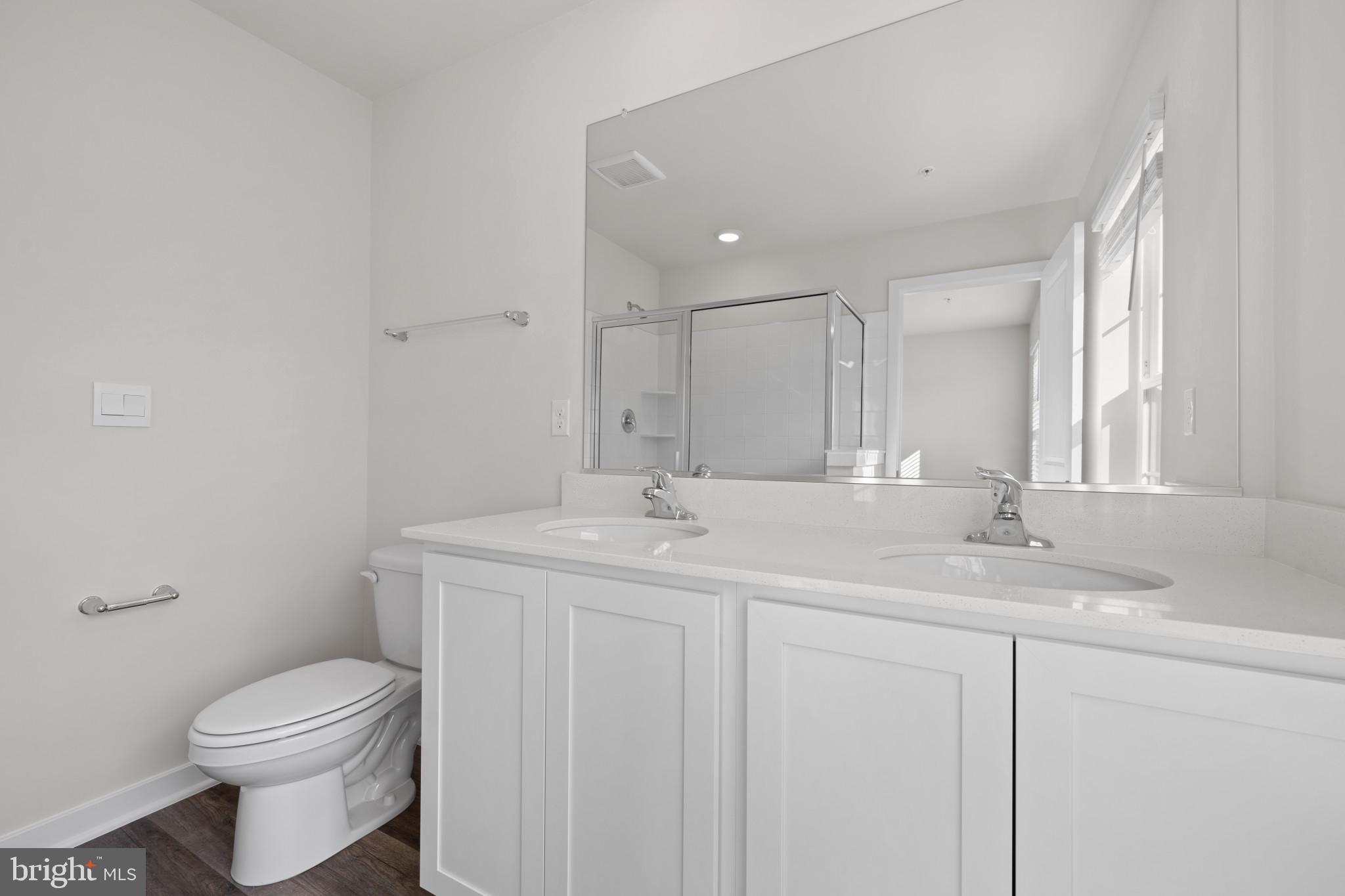 7512 Fern Gully Way Brandywine, MD 20613 - Photo 23 of 26 a bathroom with a granite countertop toilet sink and mirror