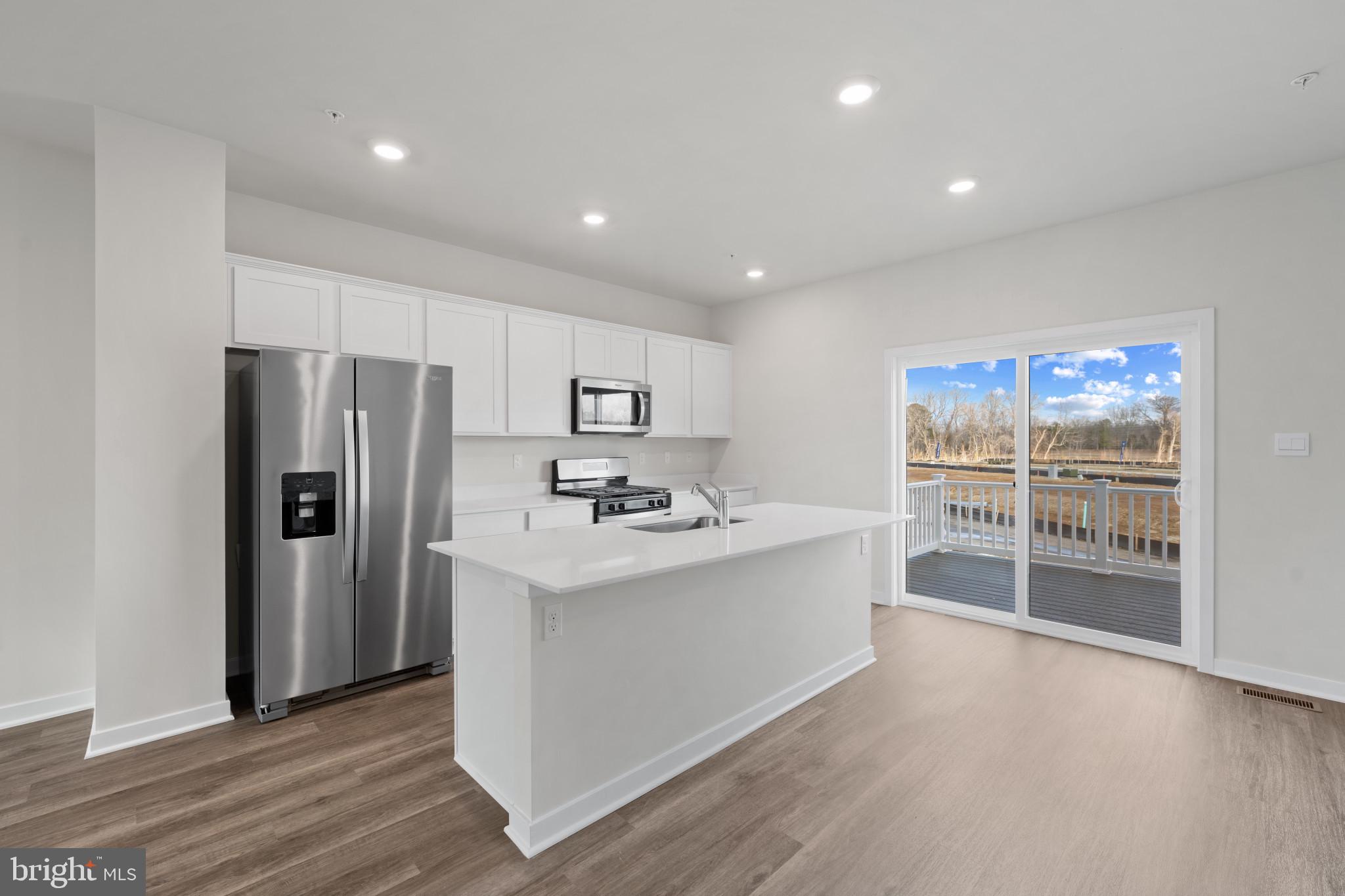 7512 Fern Gully Way Brandywine, MD 20613 - Photo 9 of 26 a view of a kitchen with refrigerator and wooden floor