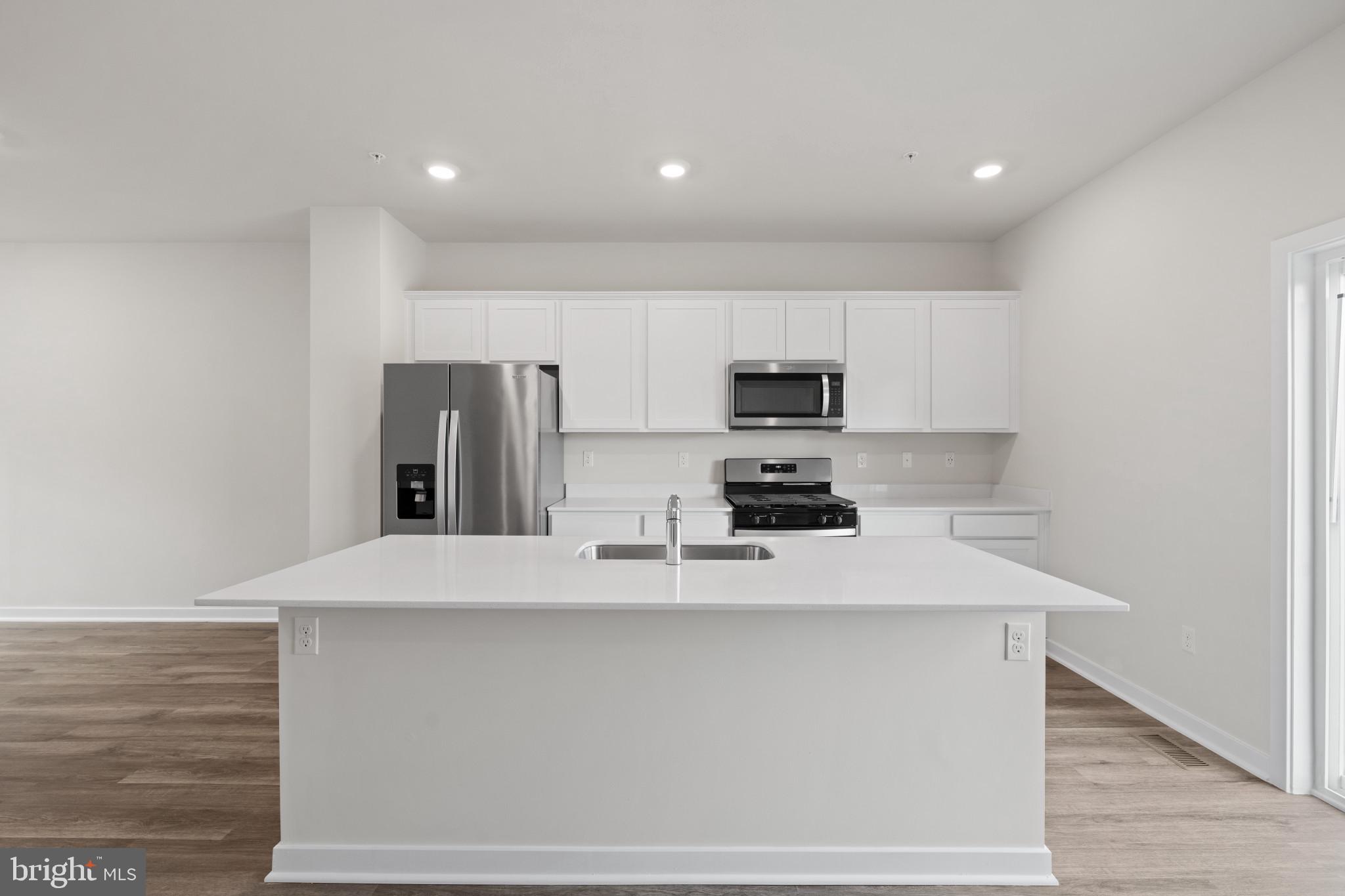 7512 Fern Gully Way Brandywine, MD 20613 - Photo 10 of 26 a kitchen with stainless steel appliances a refrigerator sink and microwave