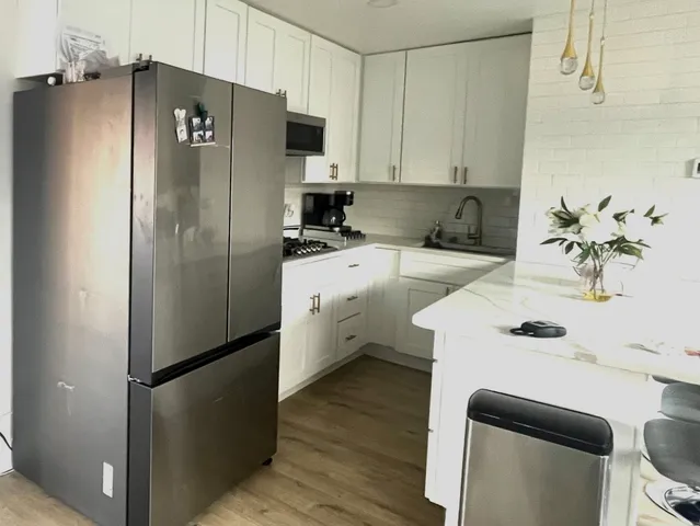 a kitchen with a refrigerator a sink and dishwasher