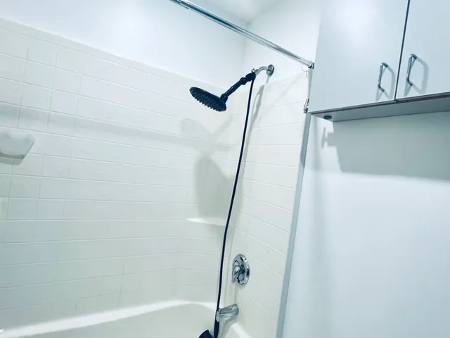 a bathroom with a shower and a glass door