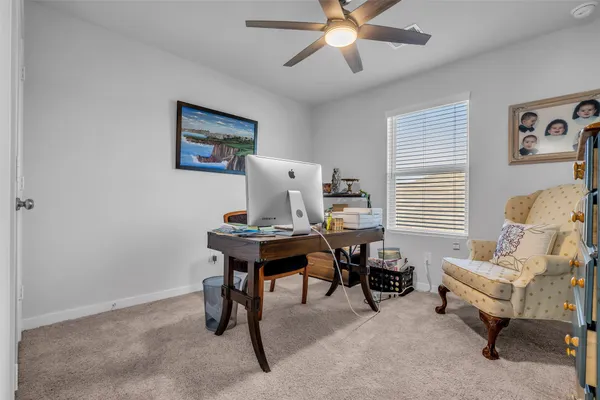 a view of a workspace with furniture and a window