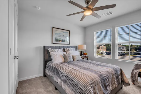 a bedroom with a large bed and a window