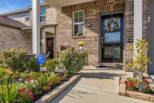 a view of a brick house with potted plants