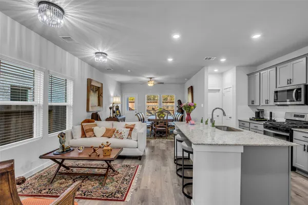 a very nice looking living room with stainless steel appliances furniture