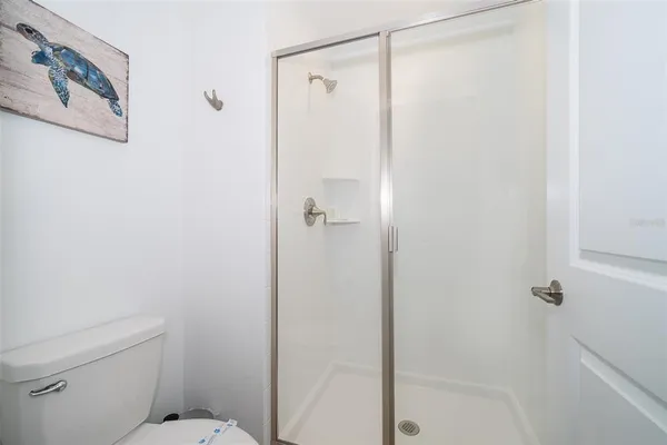 a bathroom with a shower and toilet