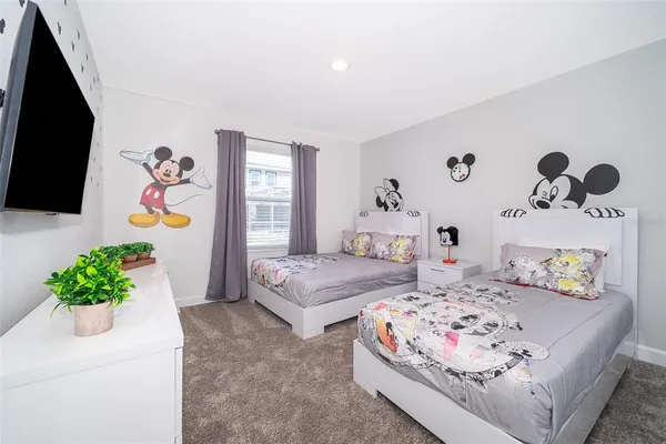 a bedroom with bed and a potted plant