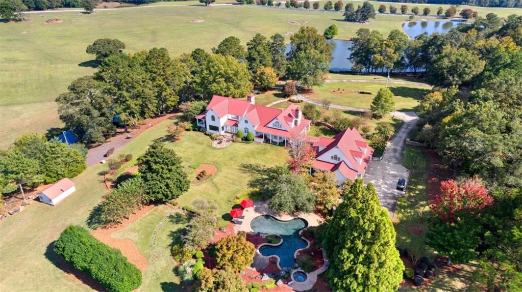 5225 Chalybeate Springs Road Woodland, GA 31836 - Photo 53 of 100 an aerial view of a house with a yard and lake view