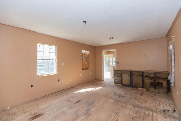 a view of a room window and wooden floor