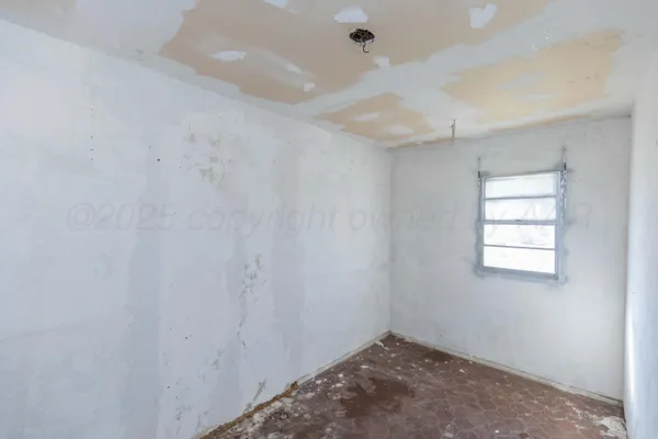 a room with a window and a bath tub