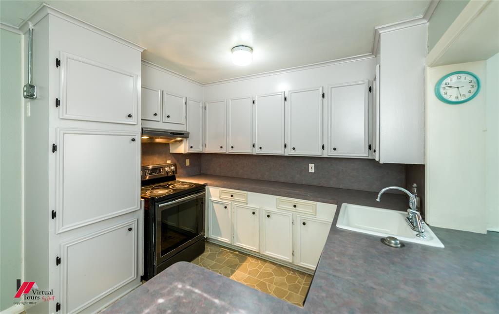 3109 Gorton Road Shreveport, LA 71119 - Photo 3 of 31 a kitchen with granite countertop a sink a stove and refrigerator