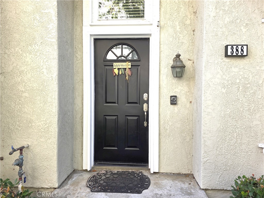 388 Fallingstar Irvine, CA 92614 - Photo 26 of 29 a view of a hallway with wooden door and glass door