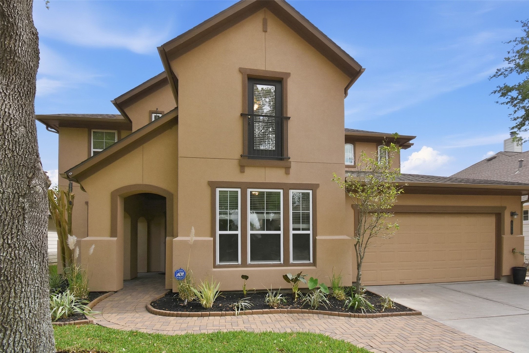 5615 Edgewood Pl Drive Spring, TX 77379 - Photo 2 of 36 Striking two-story exterior with a wide driveway, mature trees and a two-car garage, highlighted by warm lighting that enhances the home’s inviting curb appeal.