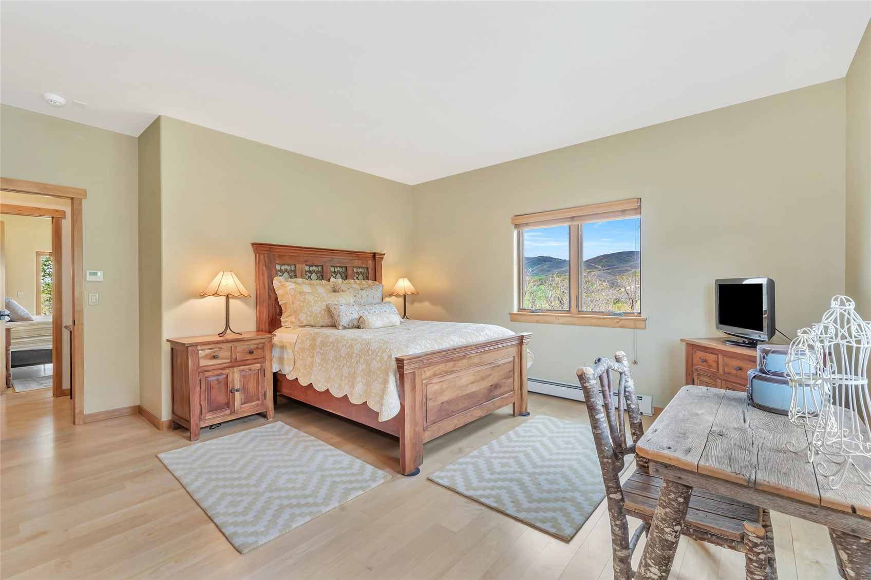 31485 Deerwood Ranch Road Steamboat Springs, CO 80487 - Photo 38 of 49 a bedroom with a bed and wooden floor