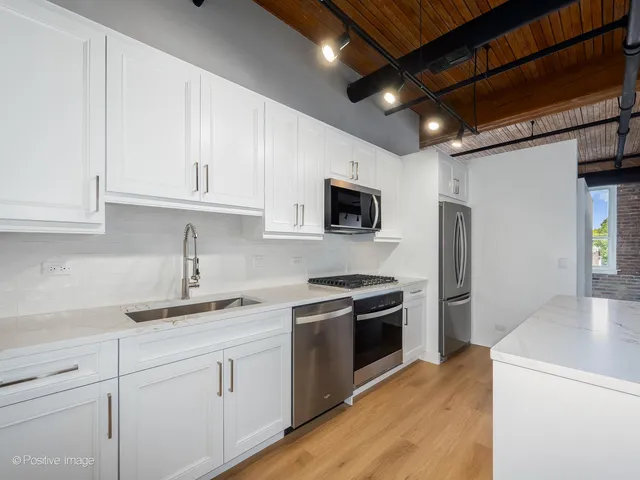 a kitchen with a sink stove and refrigerator