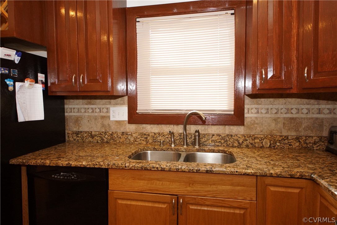 6320 Barrister Road Chesterfield, VA 23832 - Photo 8 of 22 a kitchen with granite countertop wooden cabinets a sink and a window
