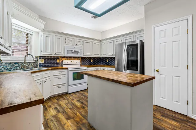a kitchen with granite countertop a sink and cabinets