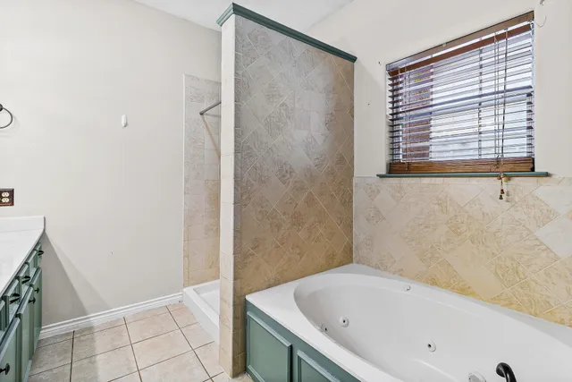 a bathroom with a bathtub and shower