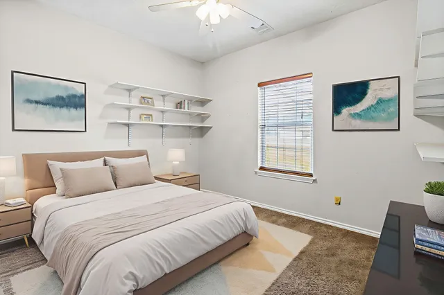 a bedroom with a large bed and a window