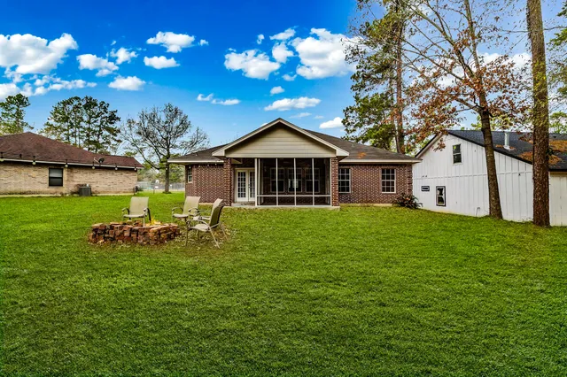 a front view of a house with garden and patio