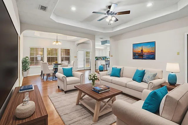 a living room with furniture potted plant and a large window