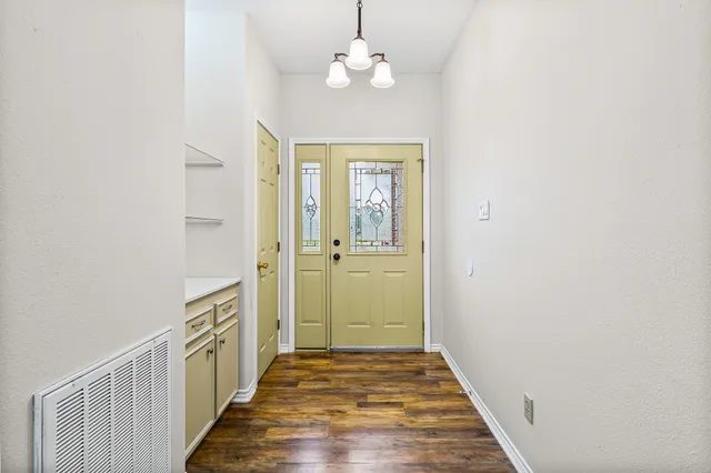 a view of a hallway with wooden floor