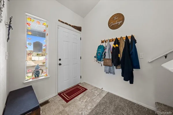 a living room with furniture and paintings on the wall