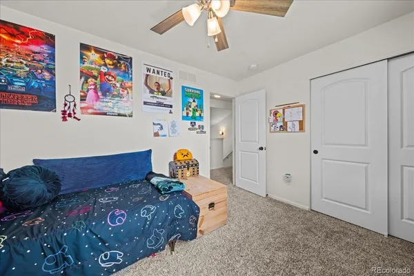 a room with furniture a ceiling fan and a window