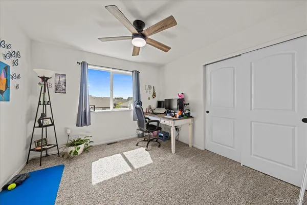a workspace with furniture and a fan