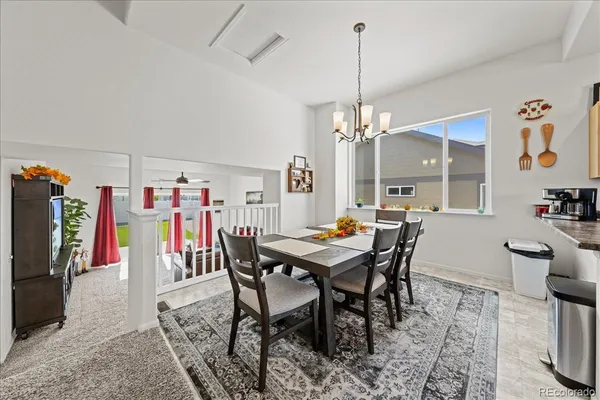 a living room with stainless steel appliances kitchen island granite countertop furniture and a dining table