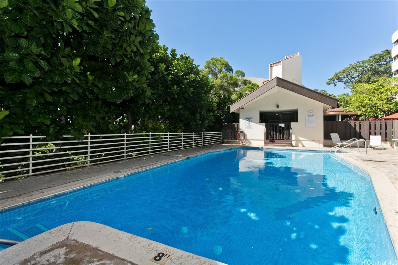 3138 Waialae Avenue, Unit 330 Honolulu, HI 96816 - Photo 12 of 17 a view of a patio with table and chairs with wooden floor and fence