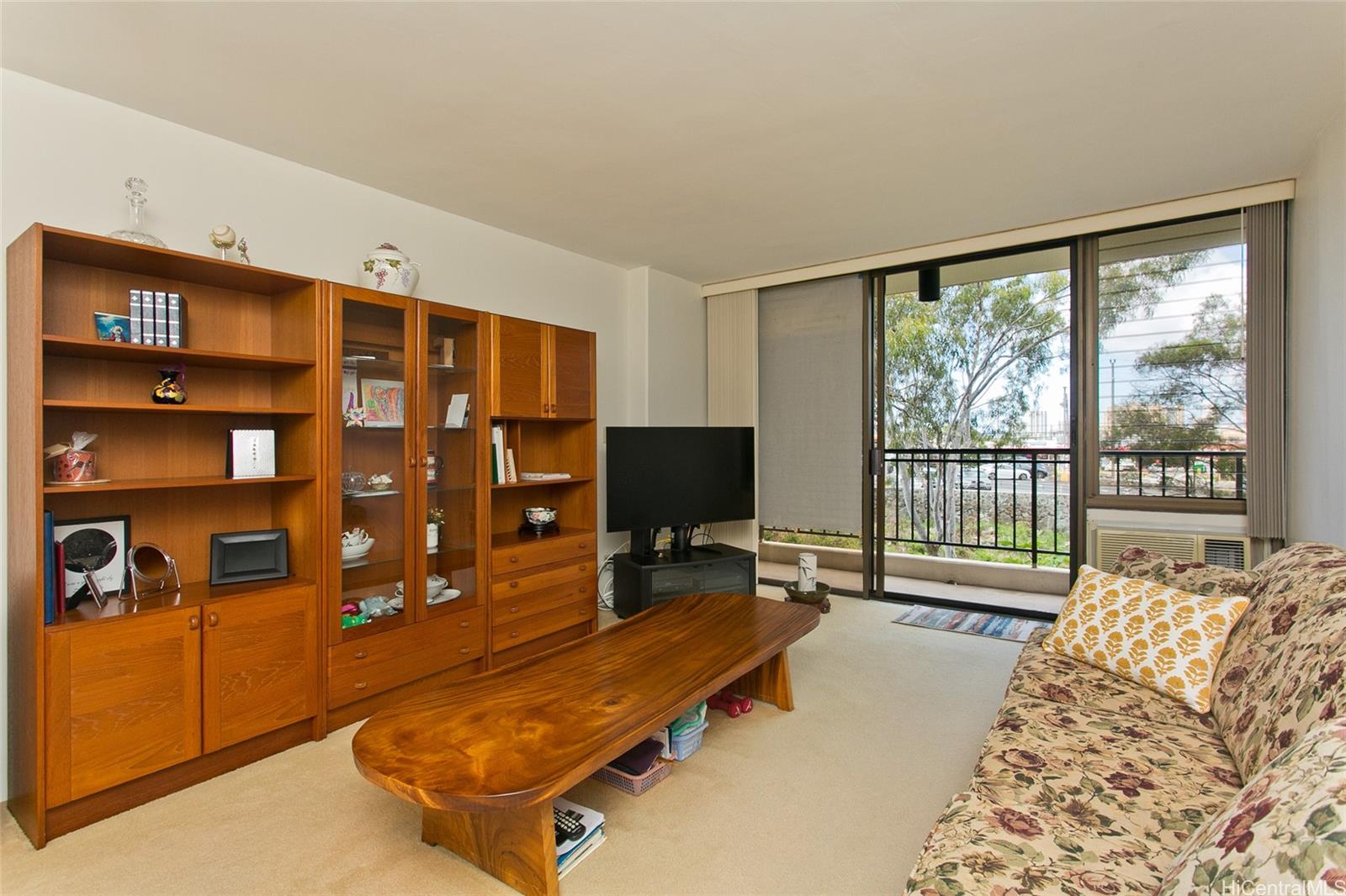 3138 Waialae Avenue, Unit 330 Honolulu, HI 96816 - Photo 3 of 17 a living room with couch a large window and bookshelf