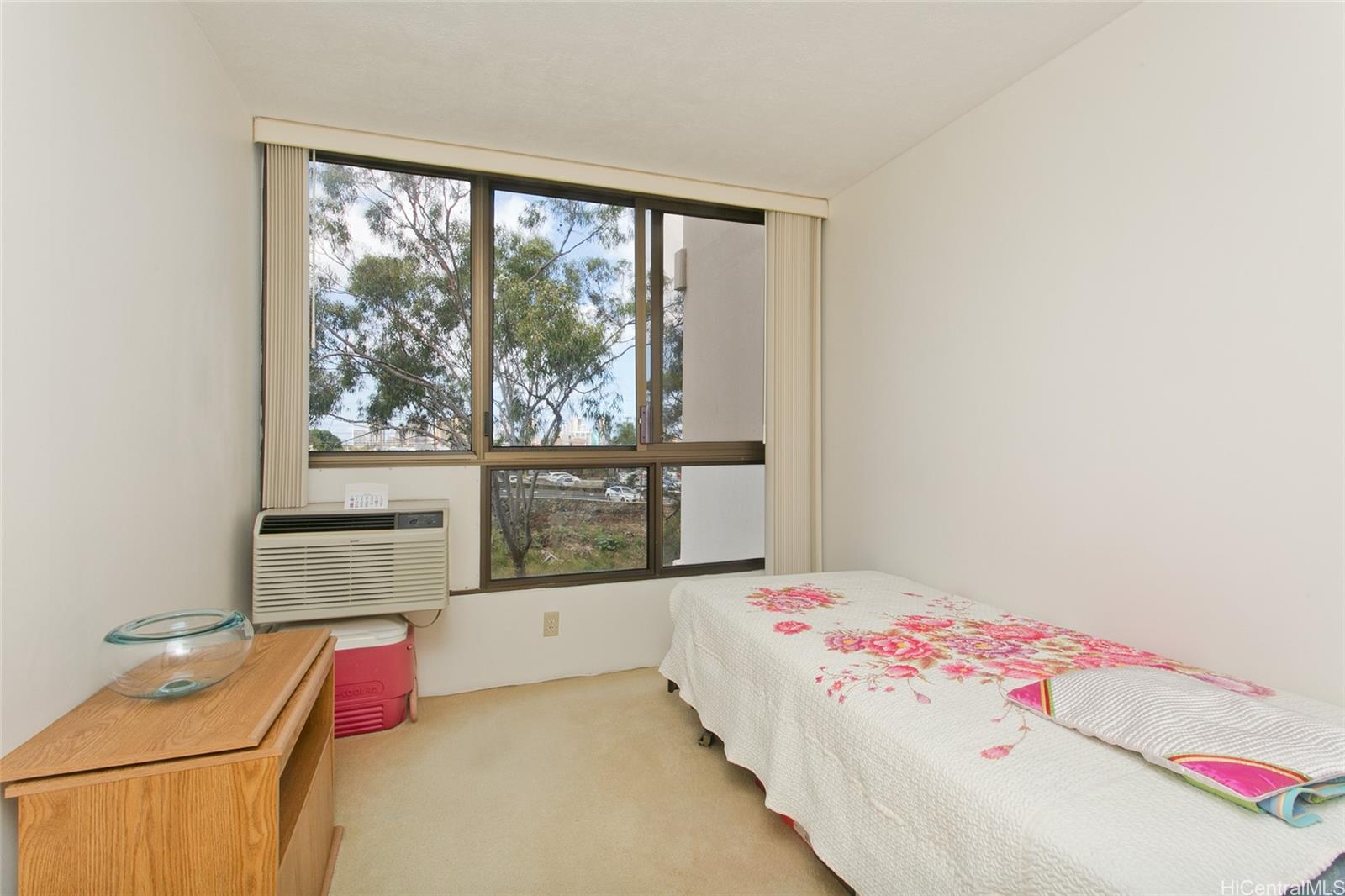 3138 Waialae Avenue, Unit 330 Honolulu, HI 96816 - Photo 6 of 17 a bedroom with a bed and wooden floor