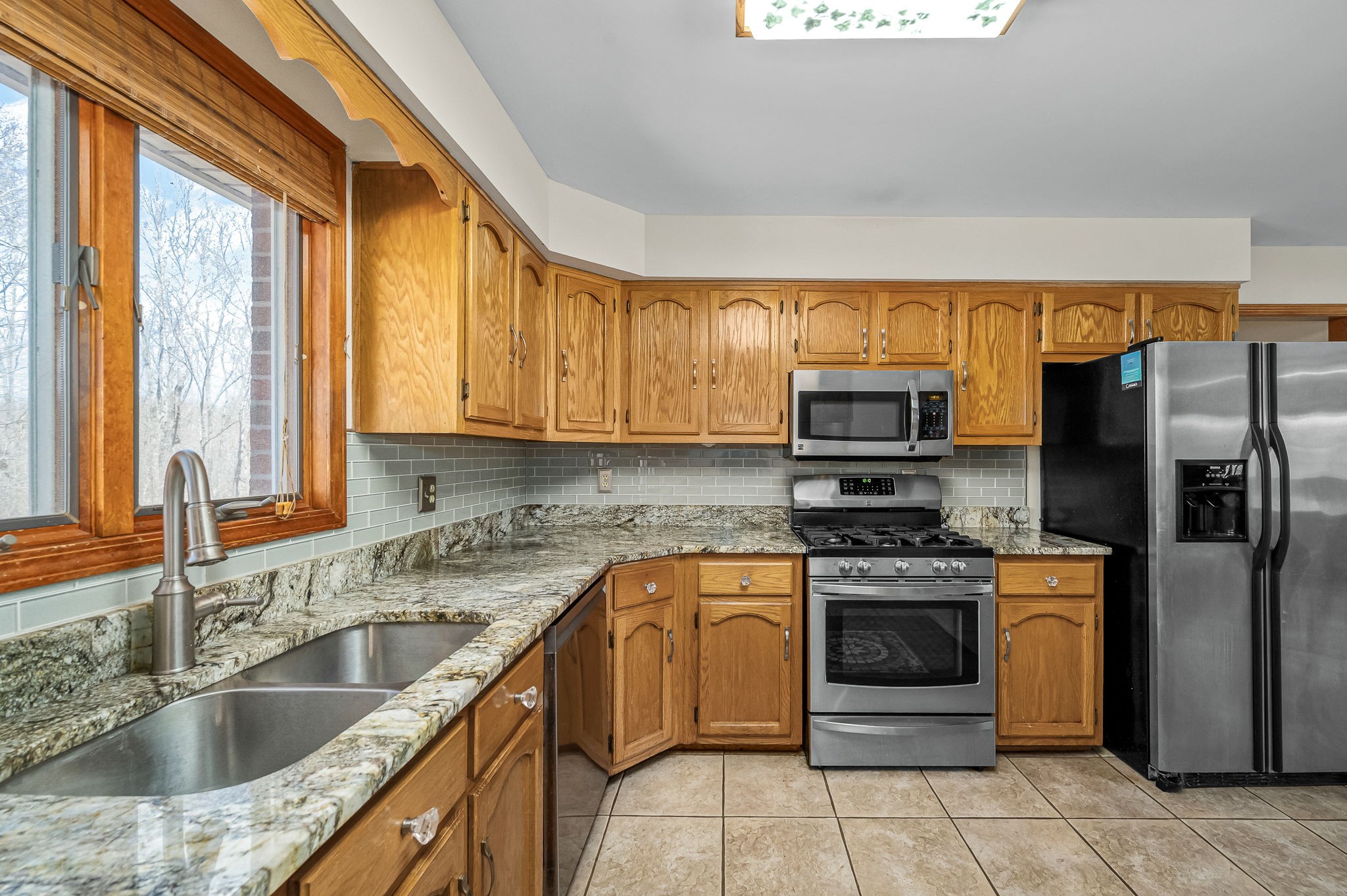 1246 Oakwood Road Joelton, TN 37080 - Photo 13 of 61 a kitchen with stainless steel appliances granite countertop a sink stove and refrigerator