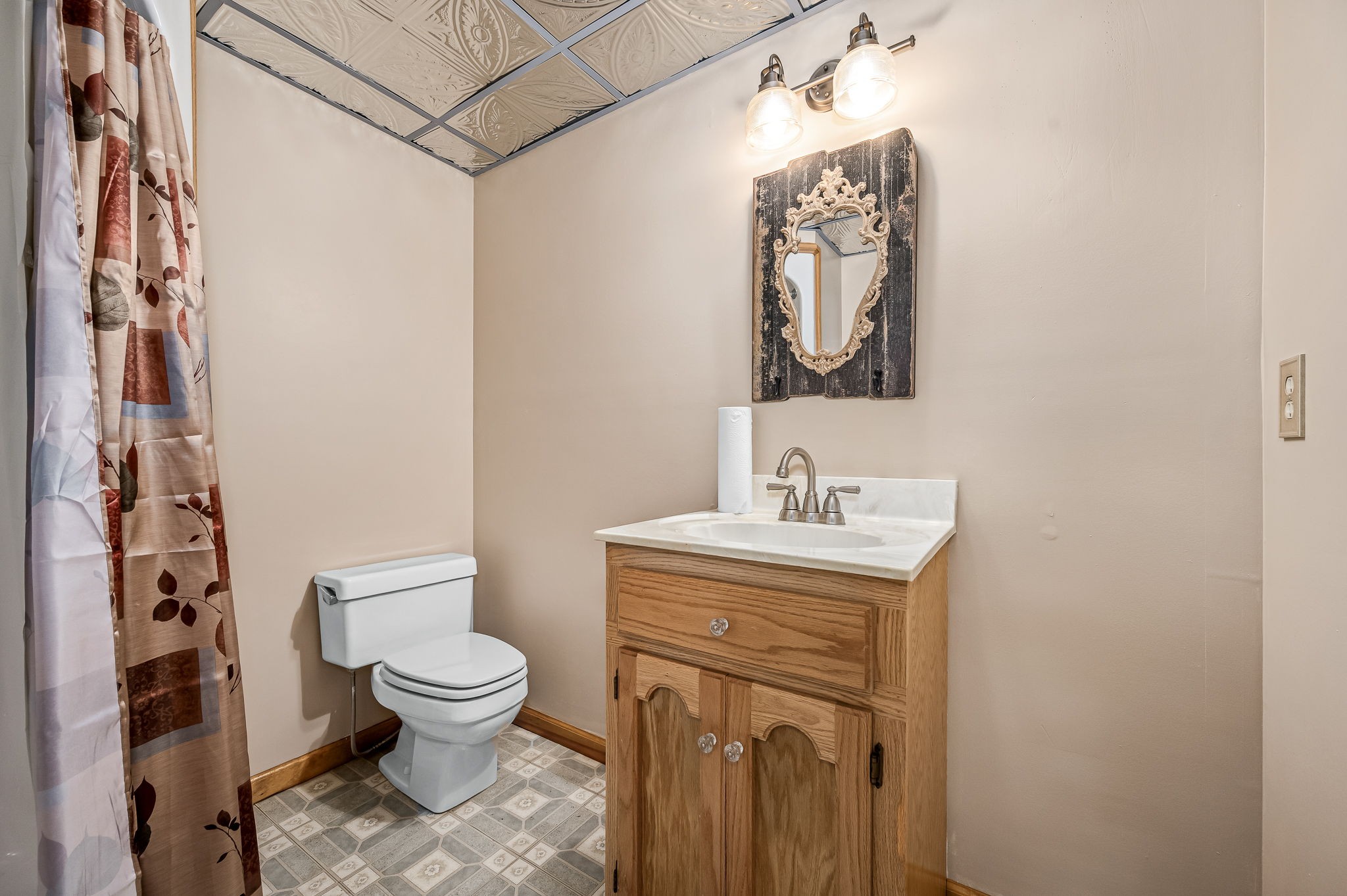 1246 Oakwood Road Joelton, TN 37080 - Photo 33 of 61 a bathroom with a toilet sink vanity and mirror