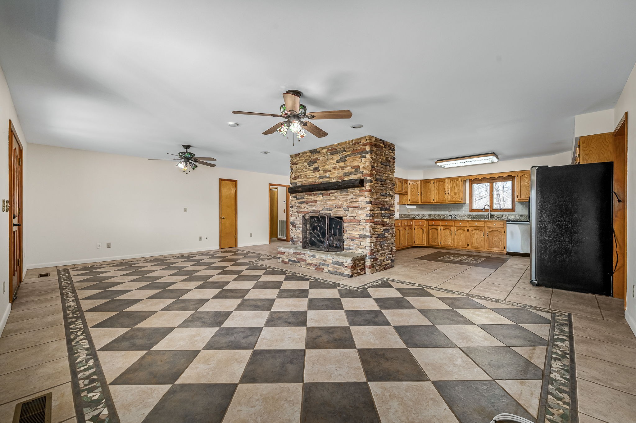 1246 Oakwood Road Joelton, TN 37080 - Photo 7 of 61 a view of a livingroom with a dinning area hardwood floor and a ceiling fan